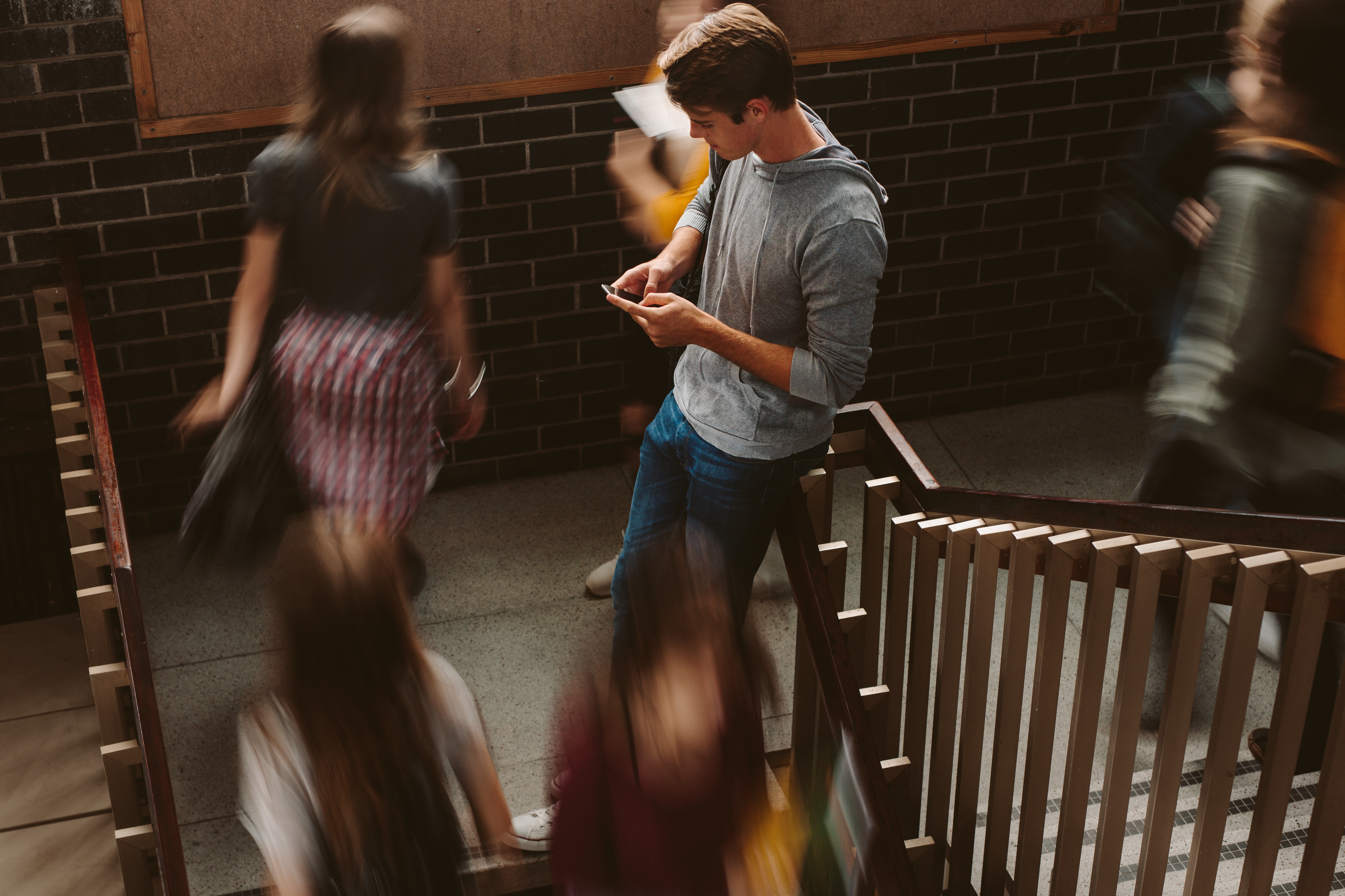 Student leaning on a banister